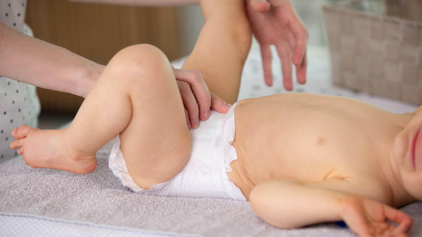 Mother changing baby's nappy