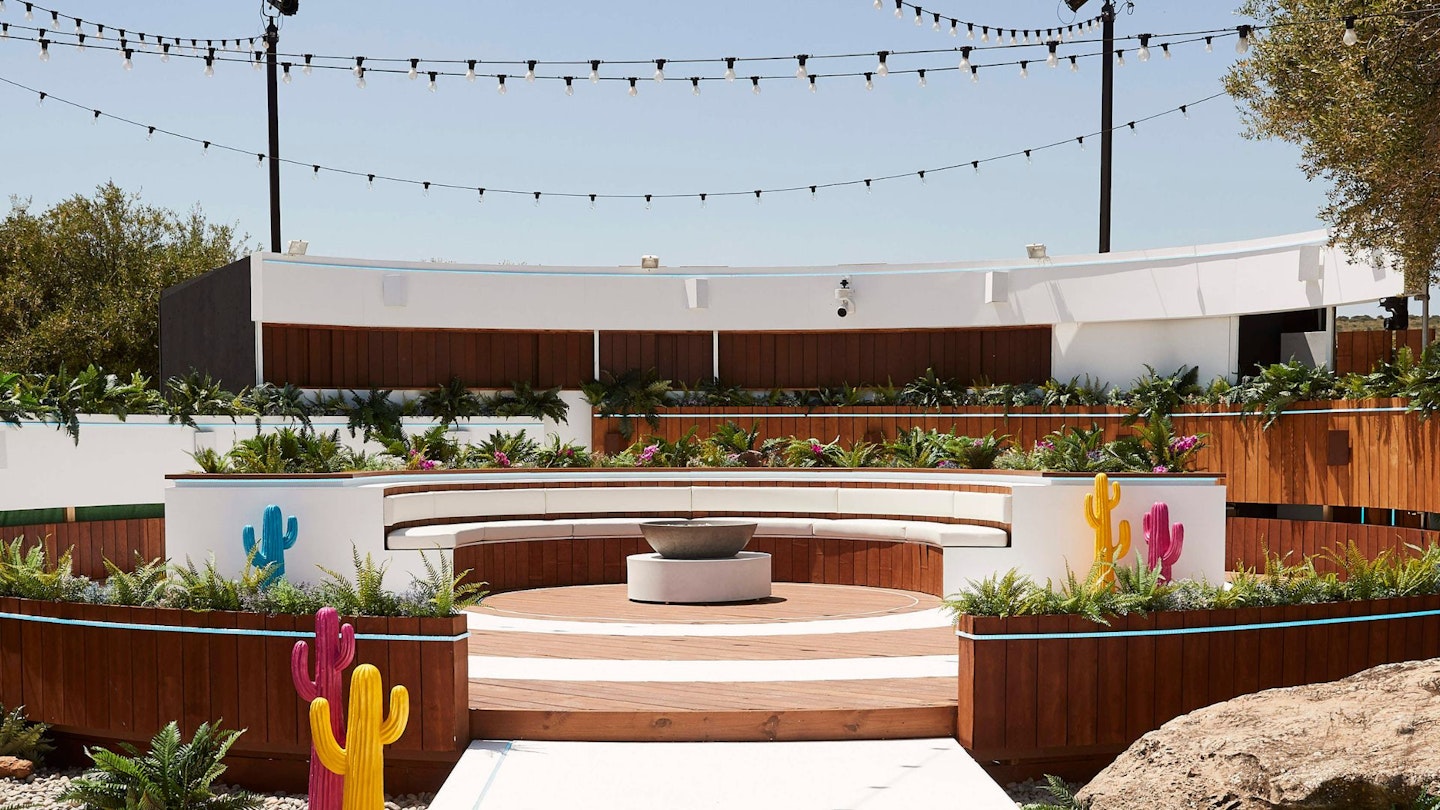 Love Island villa exterior shot with fire pit centre